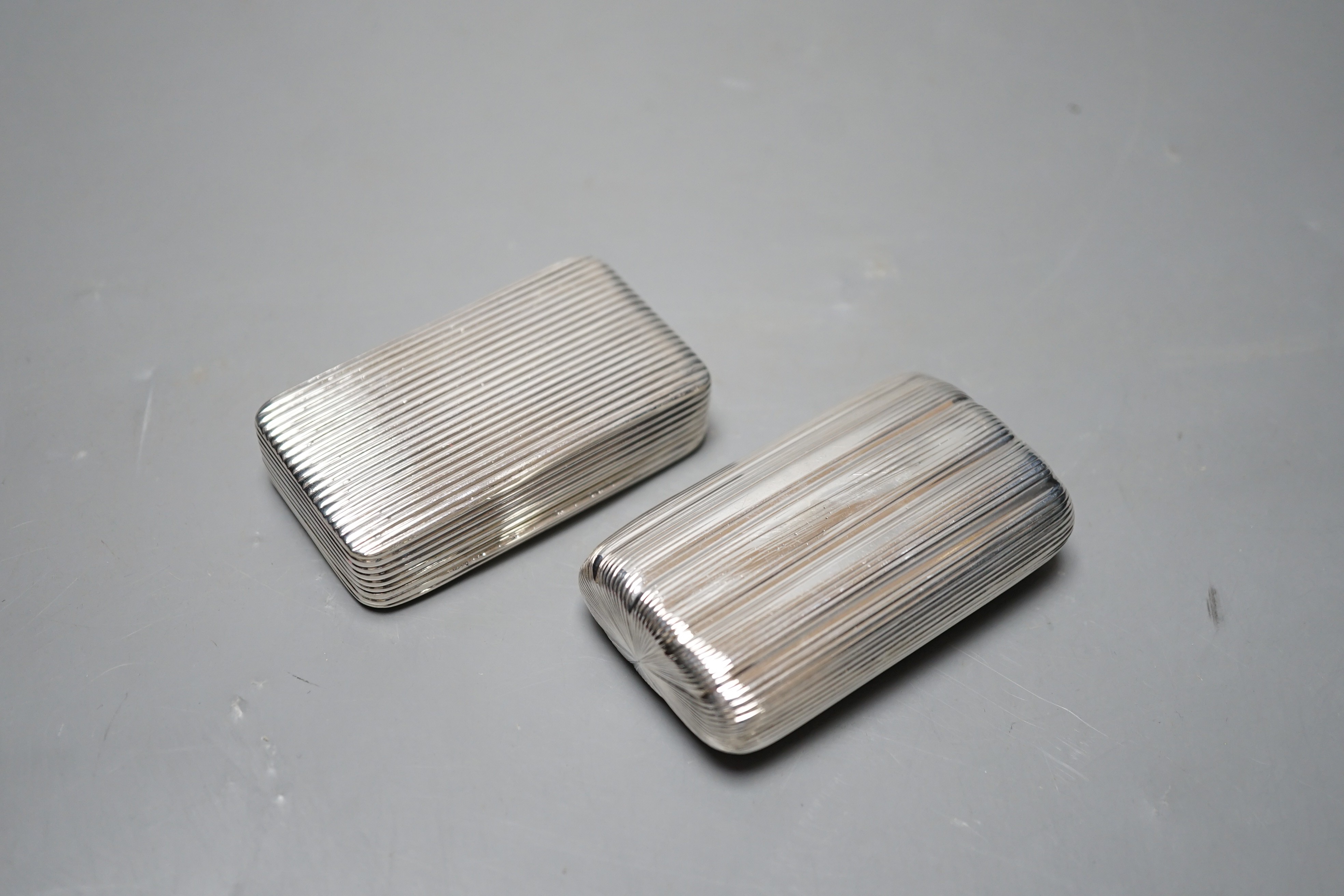 A George III ribbed silver snuff box, Londonm 1799, 72mm and one other similar later ovoid snuff box, TS, Birmingham, 1827.